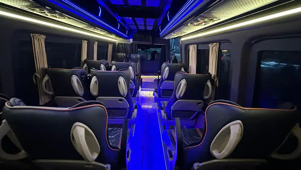 Coach interior showing blue floor lighting and seating rows