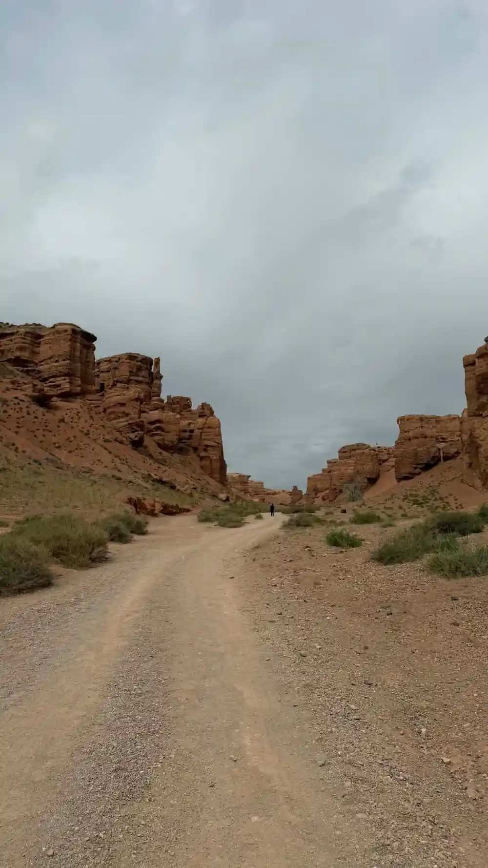 Dirt road through red rock canyon formations