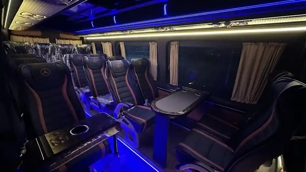 Interior of coach with purple lighting and reclining seats