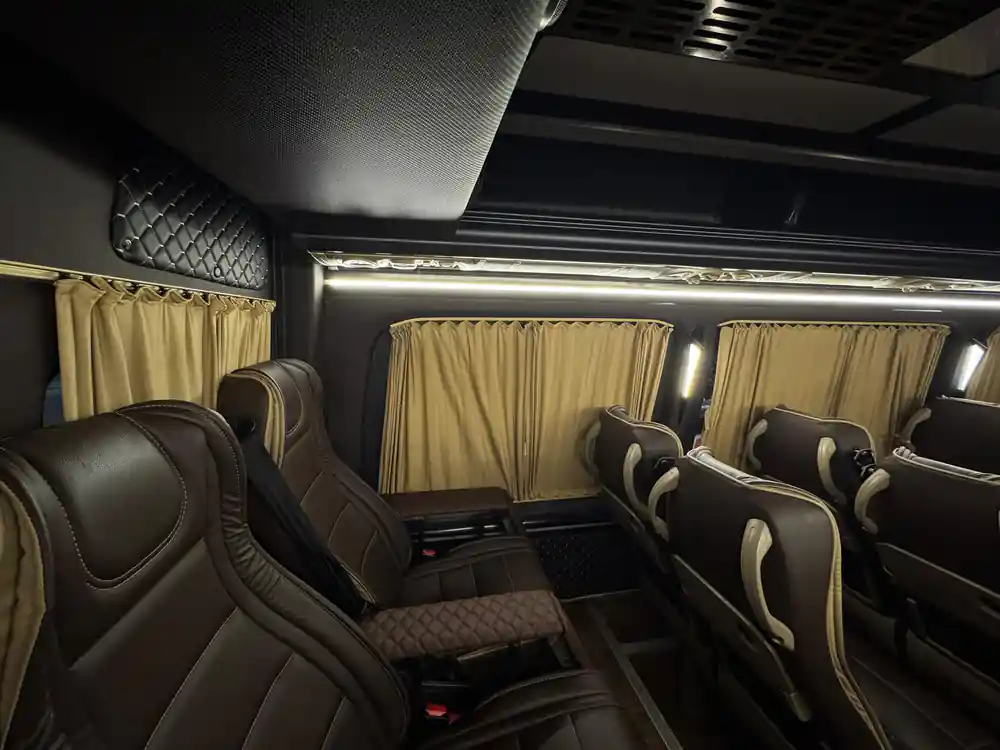 Interior view of luxury coach seating area with cream curtains