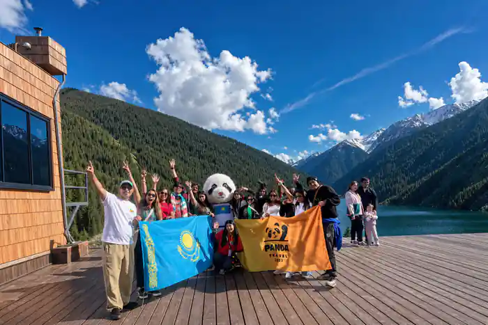 Large group with panda mascot holding Kazakhstan flag