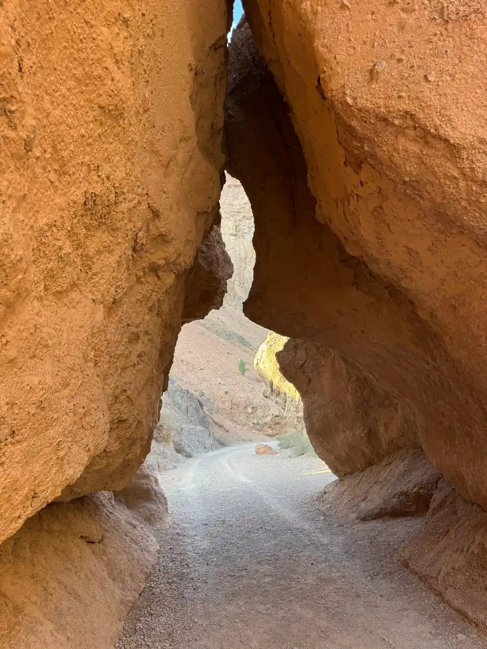 Narrow passage between two tall red rock walls