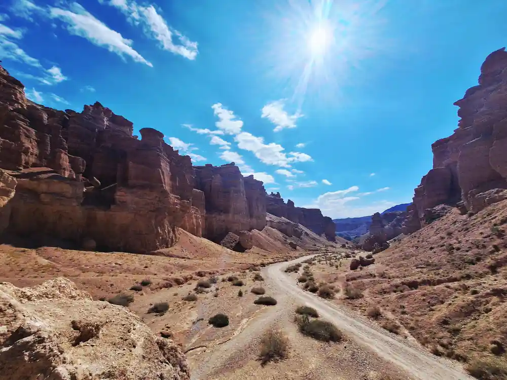 Red rock canyon with dirt road through arid landscape