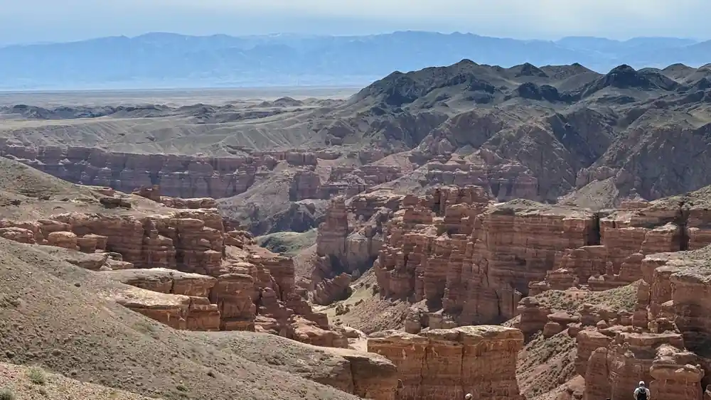 Red rock formations and canyon under clear blue sky