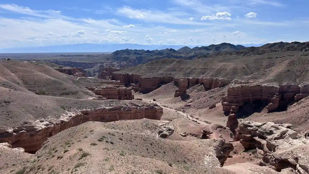 Red rock formations and canyon landscape with distant mountains