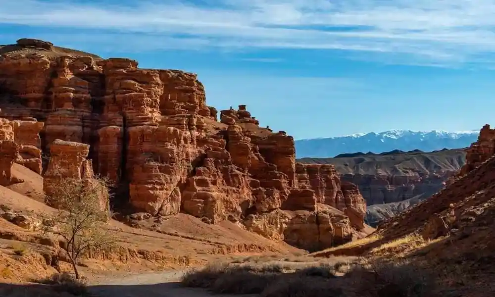 Red rock formations and canyon landscape with distant mountains