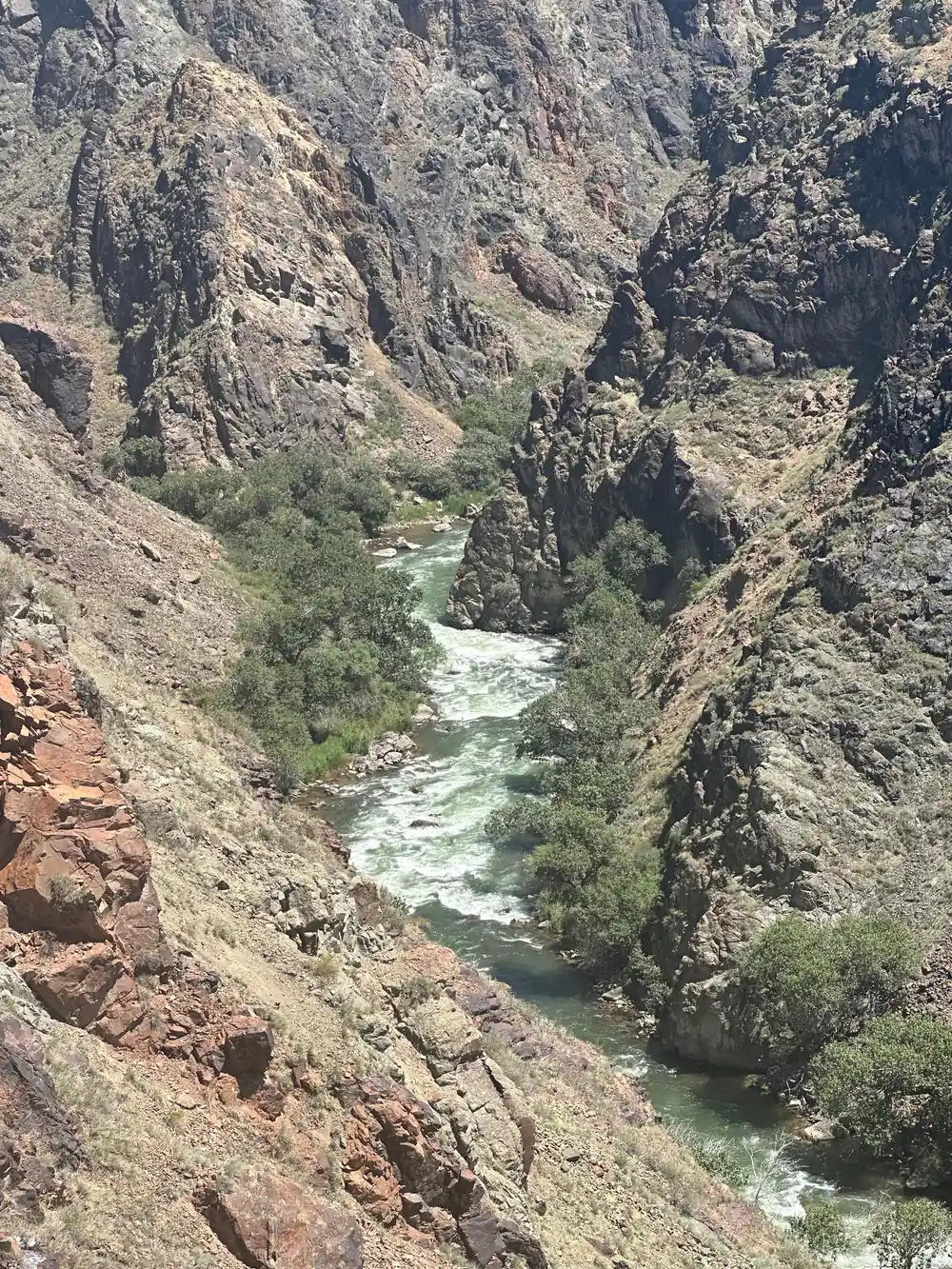 White river flowing between steep rocky canyon walls